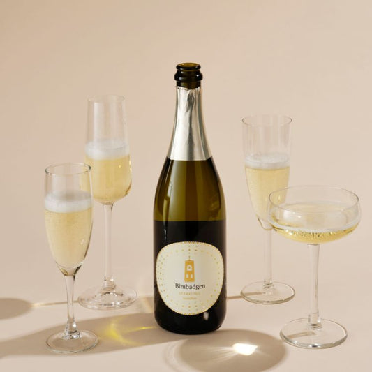 A bottle of Bimbadgen Blanc De with several glass of wine