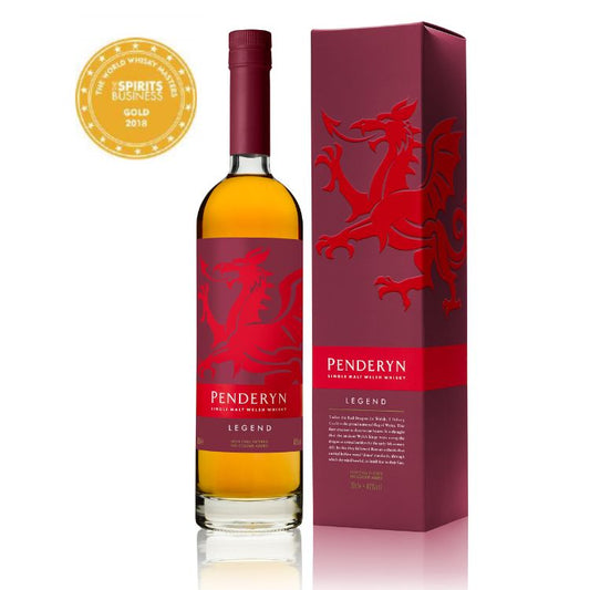A bottle of Penderyn Welsh Single Malt Whisky with a red label featuring a red dragon, alongside a box with the same design and a gold award seal.