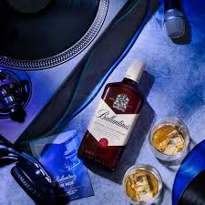 Bottle of Johnnie Walker Blue Label whisky with snacks on a blue surface