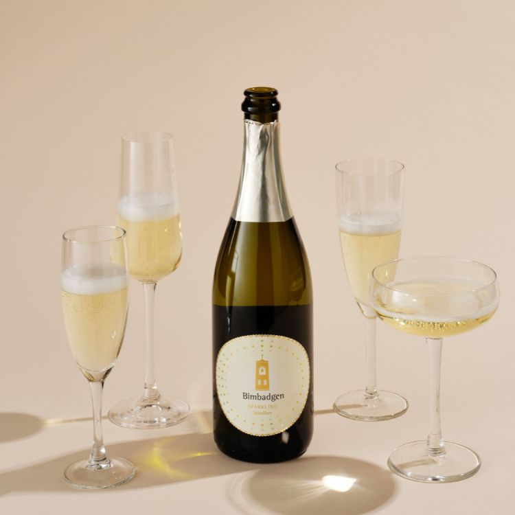 A bottle of Bimbadgen Blanc De with several glass of wine