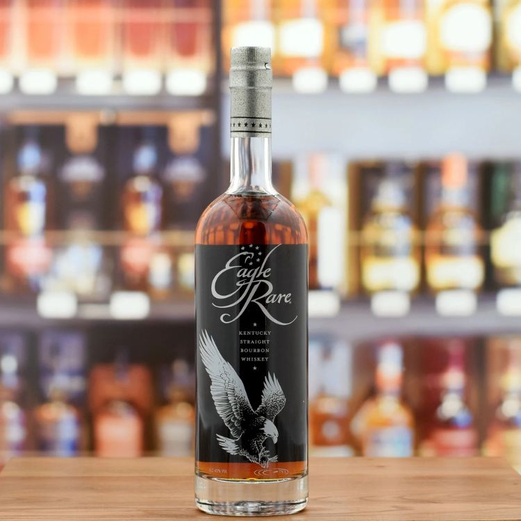 Bottle of Eagle Rare whiskey on a bar shelf with blurred background