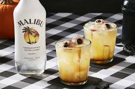 Malibu bottle with two cocktails on a checkered tablecloth