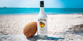 Malibu bottle with a coconut on a beach