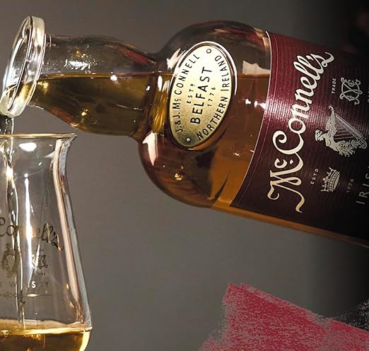 McConnell's Sherry Cask Finish Irish Whisky pored into glass of wine