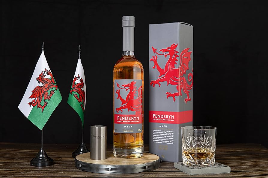 Showcase of Penderyn Welsh Single Malt Whisky Dragon Range Myth with a shot glass and flags