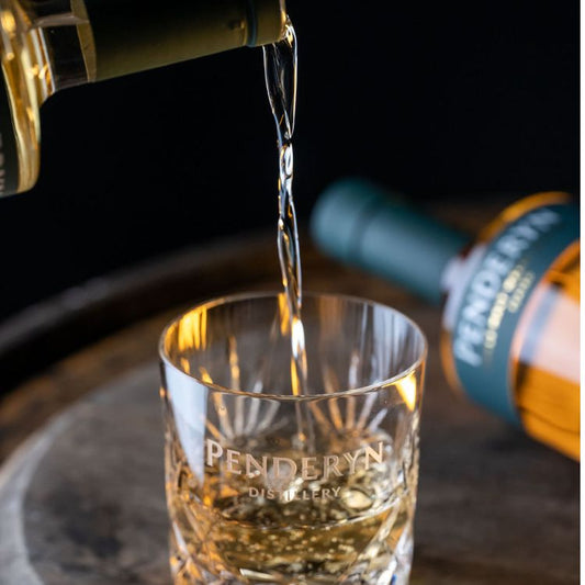 Pouring shot of Penderyn Welsh Single Malt Whisky Peated Gold Range 