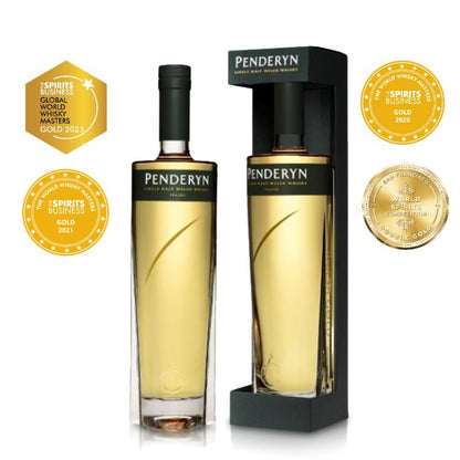 A bottle of Penderyn Welsh Single Malt Whisky from the Peated Gold Range, displayed in a black and gold packaging with a glass bottle visible in the foreground. The background includes a label stating 'Aur Cymru' and medals won by the product.