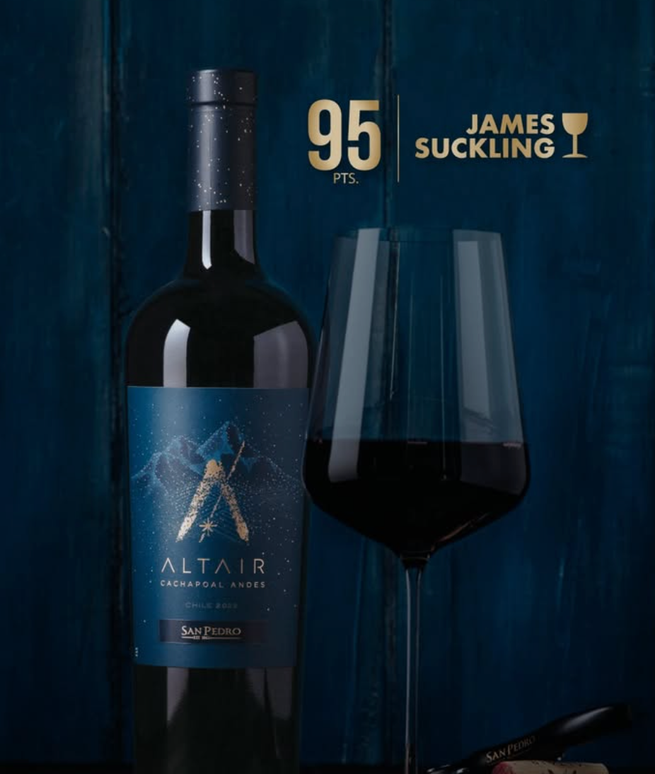 Bottle of Altair wine with a glass and James Suckling score on a dark background