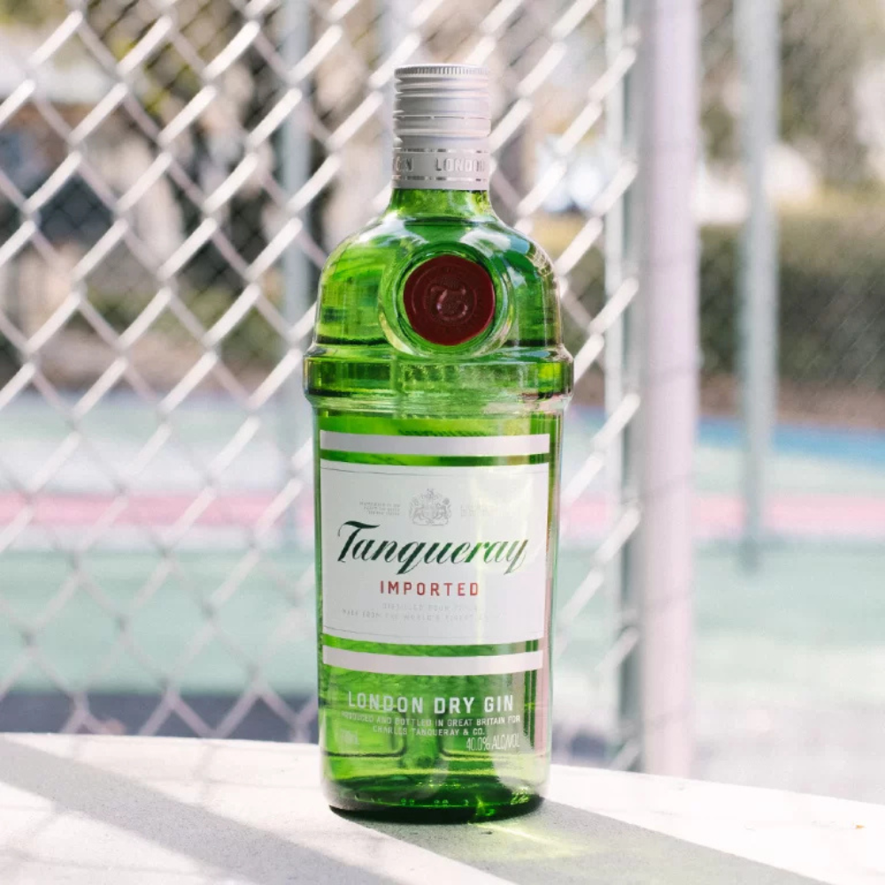 Tanqueray gin bottle on a surface with a blurred background