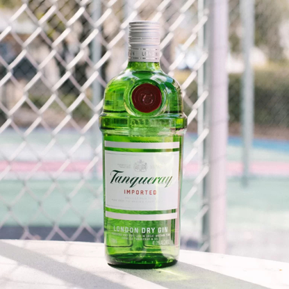 Tanqueray gin bottle on a surface with a blurred background