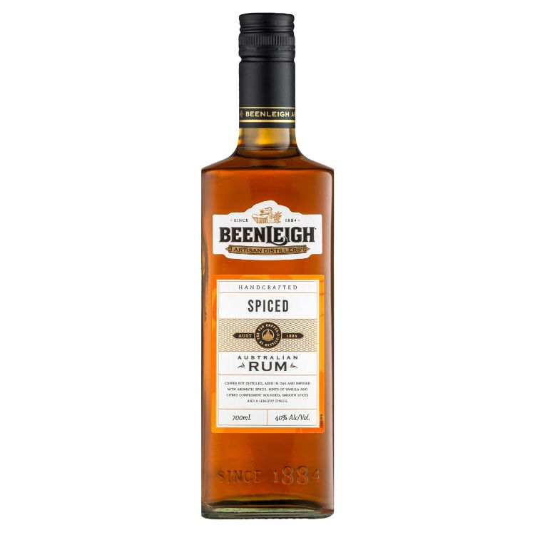 A bottle ofBeenleigh Australian Hand Crafted Spiced Rum with a label showing the brand name and the type of rum. The bottle is transparent, showcasing the amber-colored rum inside.